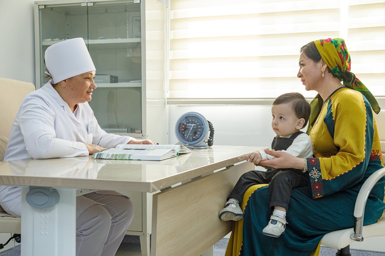 A mother and her child visit a local health facility for vaccination in Turkmenistan